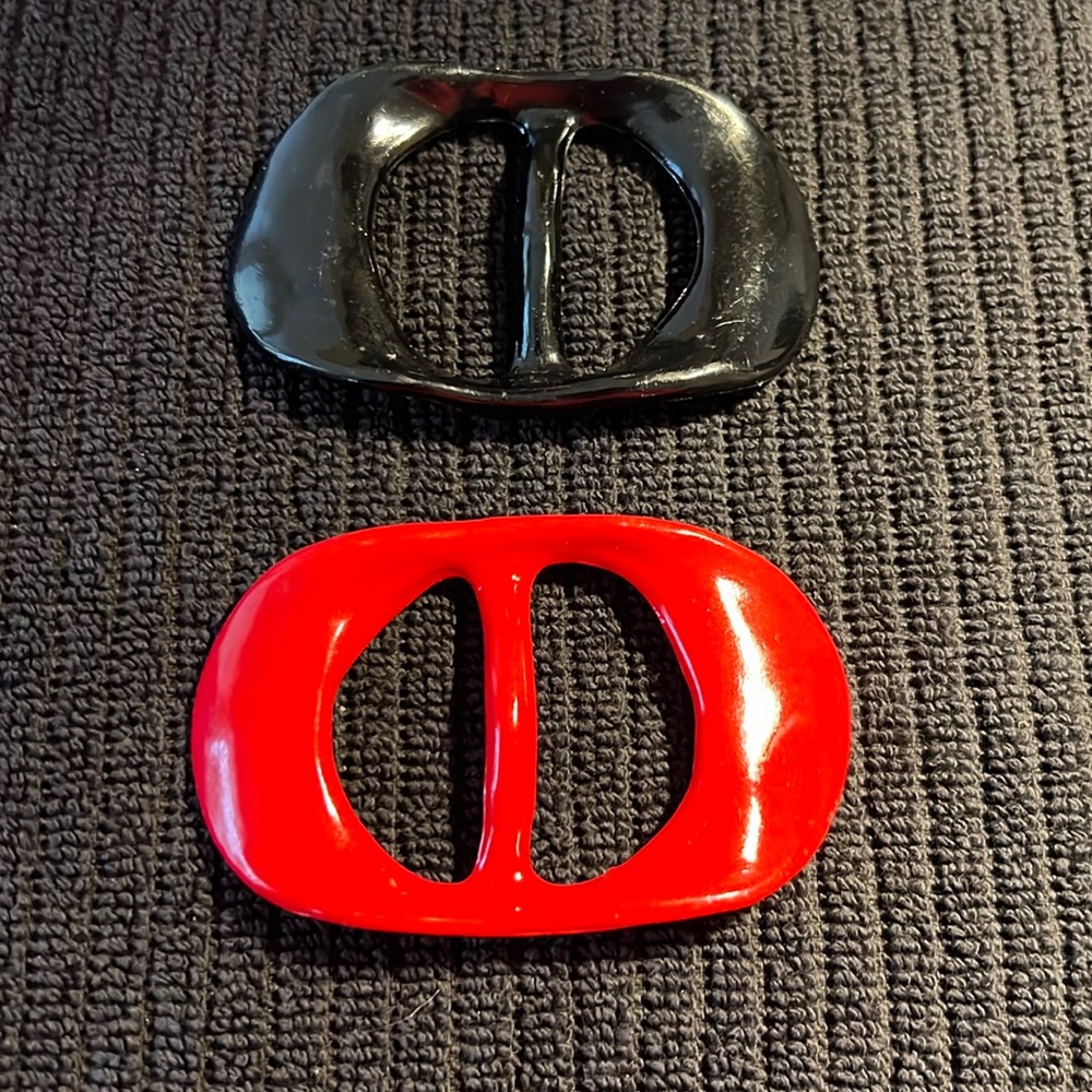 One red one black scarf or belt holders